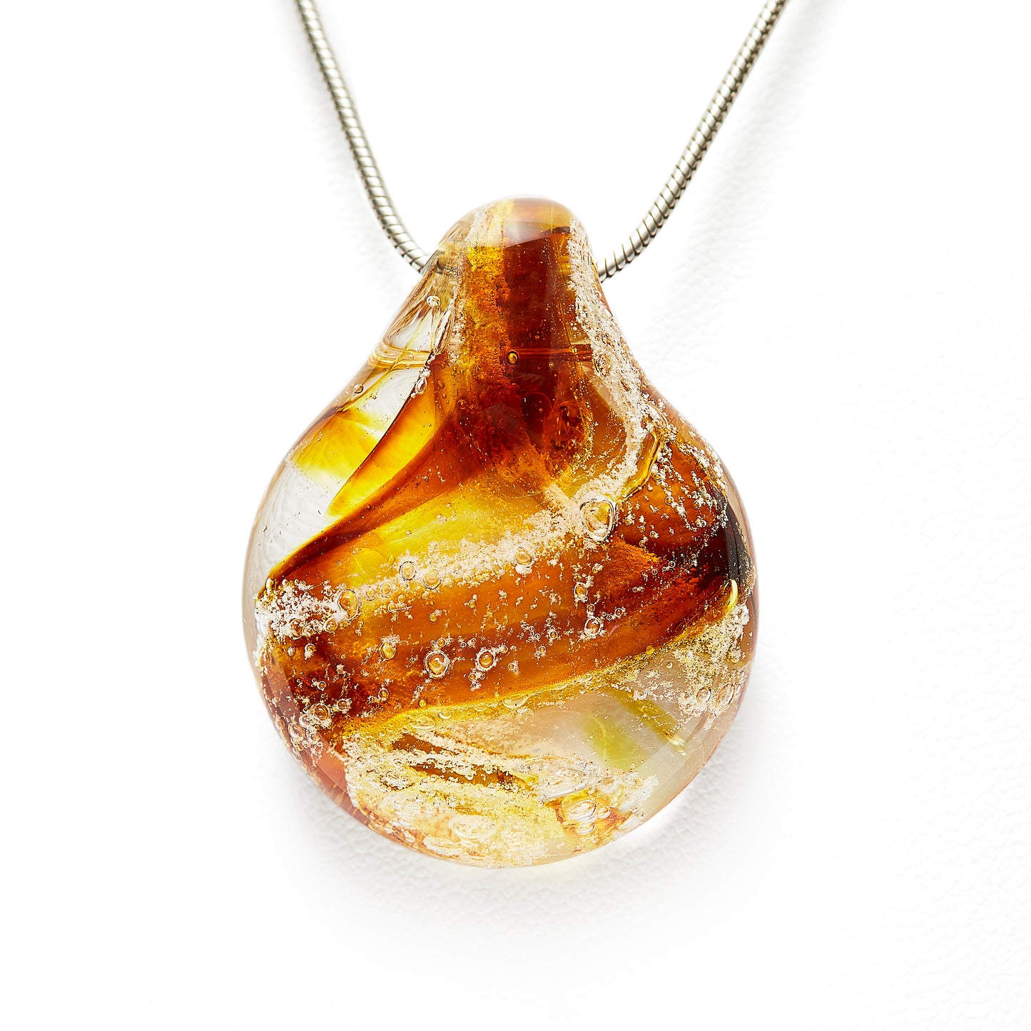 Memorial glass art pendant with cremation ash. Iris gold glass.