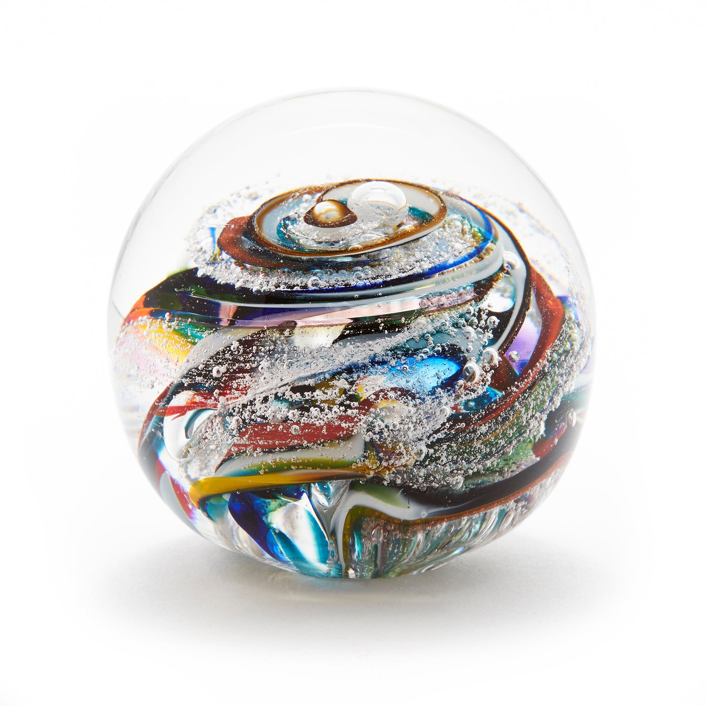 Round memorial glass art paperweight with cremation ash. Purple, blue, yellow, red, orange, green, and white glass. Colour combination is called "Multi."