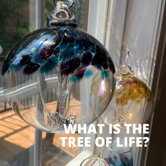 An Amethyst Teal Tree of Life glass ball hangs delicately in a window surrounded by other glass balls. Text reads: "What is the Tree of Life?"