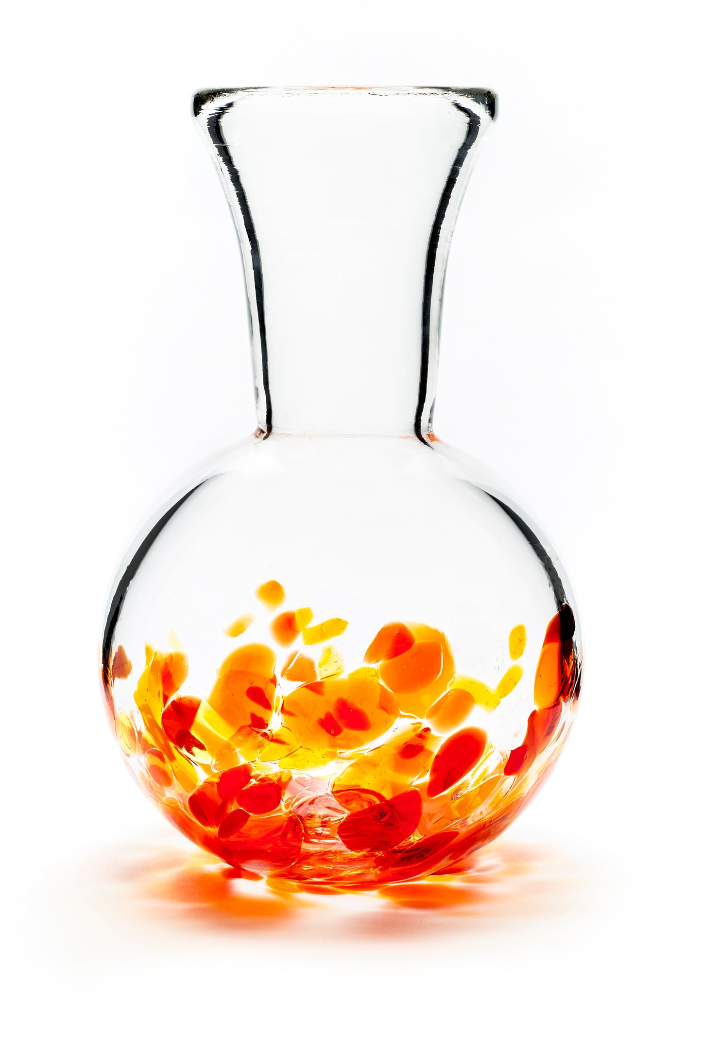 Hand blown glass vase. Red, yellow, and orange glass on the bottom. Colour combination is called "Sunburst."