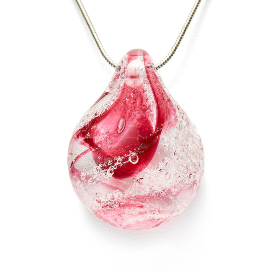 Memorial glass art pendant with cremation ash. Cranberry glass.