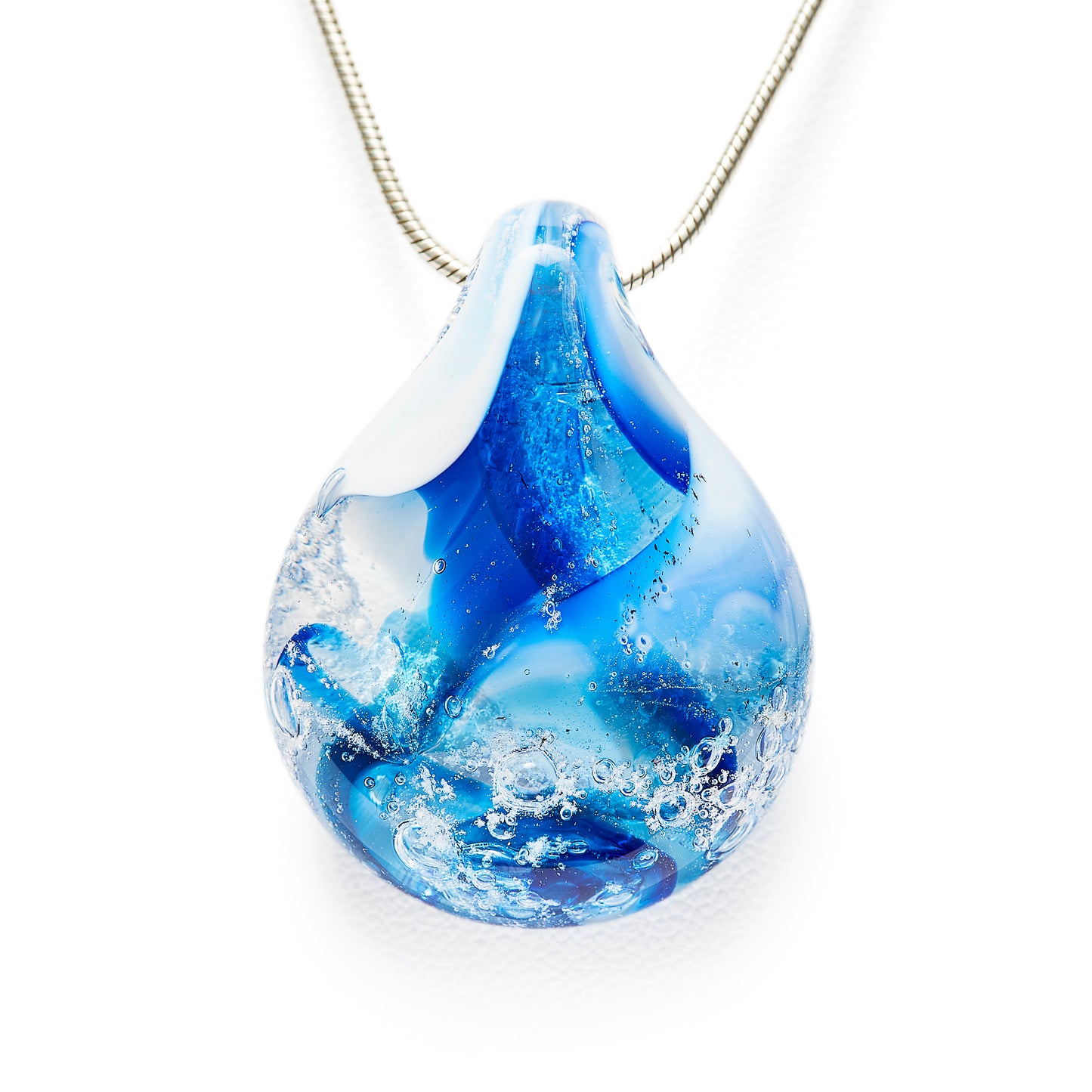 Memorial glass art pendant with cremation ash. Cobalt blue, teal blue, and white glass. Colour combination is called "Winter."