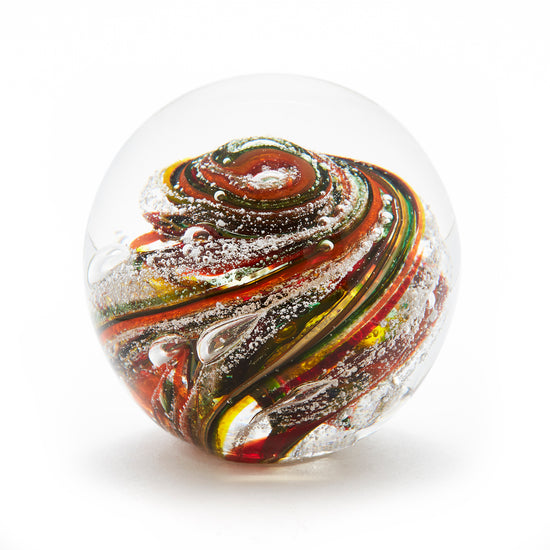 Round memorial glass art paperweight with cremation ash. Yellow, red, orange, and green glass. Colour combination is called "Autumn."