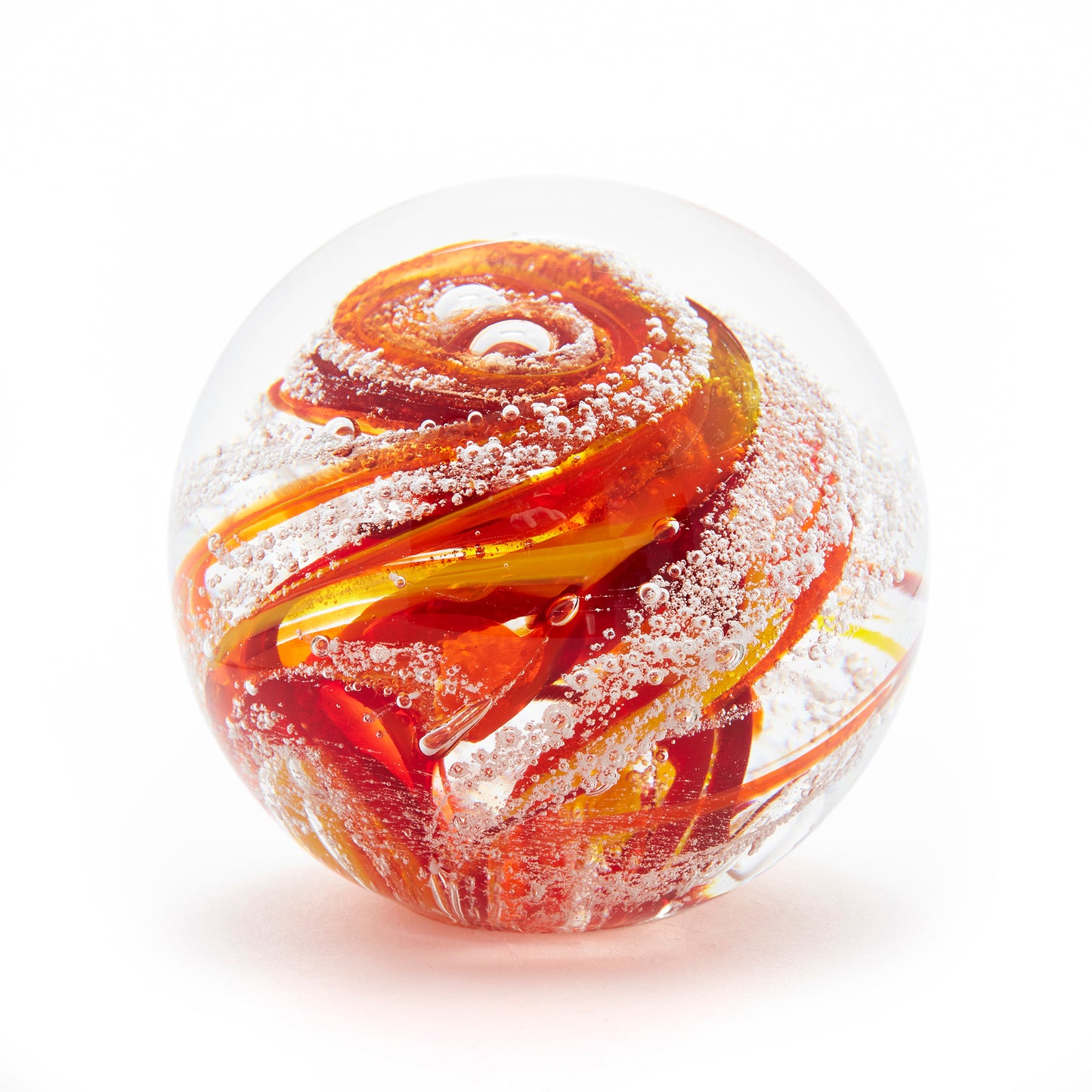 Round memorial glass art paperweight with cremation ash. Red, yellow, and orange glass. Colour combination is called "Sunburst."