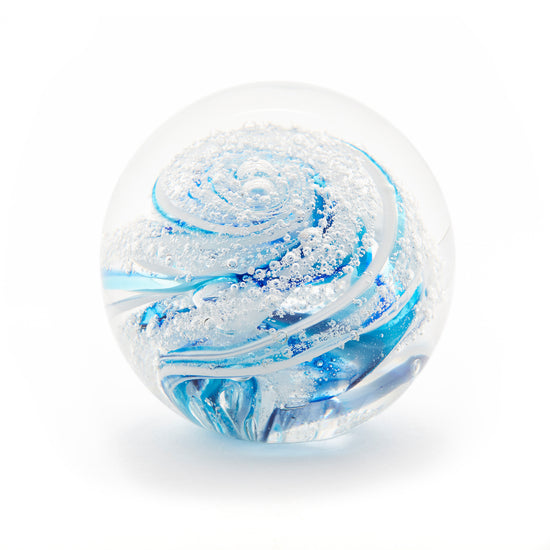 Round memorial glass art paperweight with cremation ash. Cobalt blue, teal blue, and white glass. Colour combination is called "Winter."